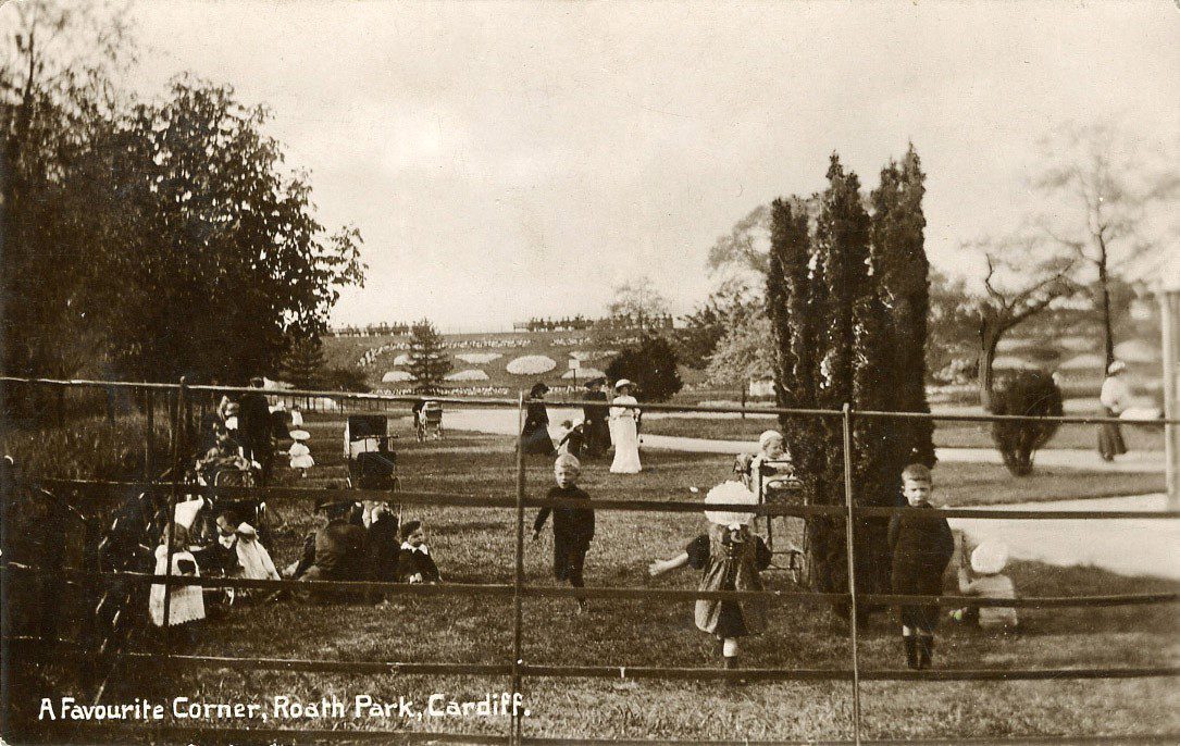 historic photo of the area surrounding the bandstand in Roath Park, with children playing on the grass