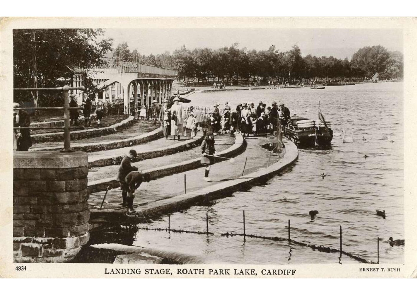 historic postcard showing boats on Roath Lake and the landing stage