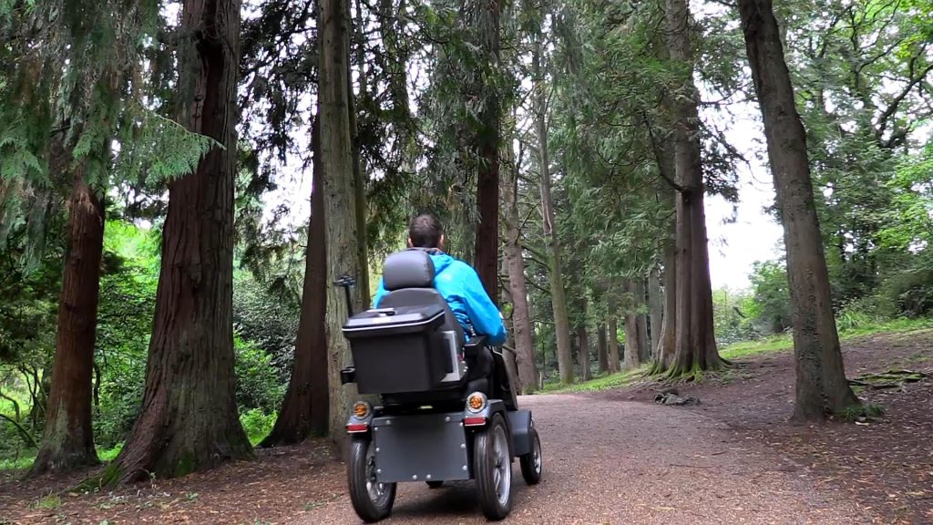 Person travelling through a forest using a tramper vehicle